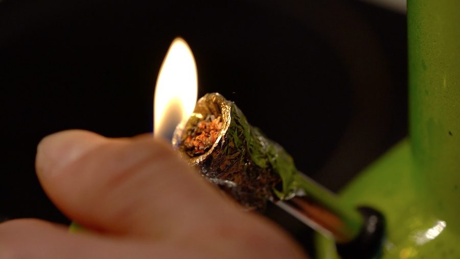 Drug taking view of someone smoking cannabis through a bong