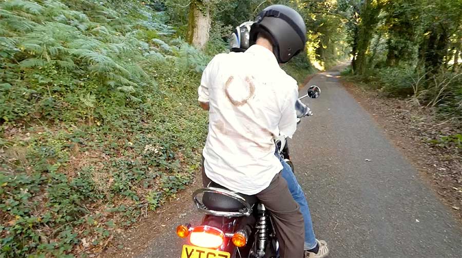 Stan hitching a ride on a motorbike