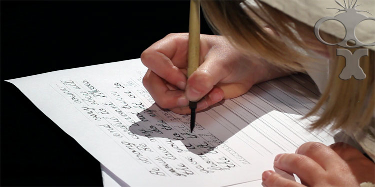 Filming students learning to use quill pens for St Annes