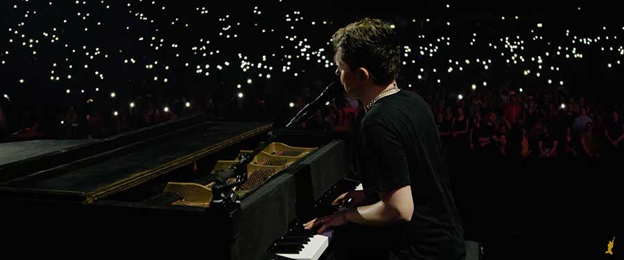 Michael Patrick Kelly plays the piano at a live performance